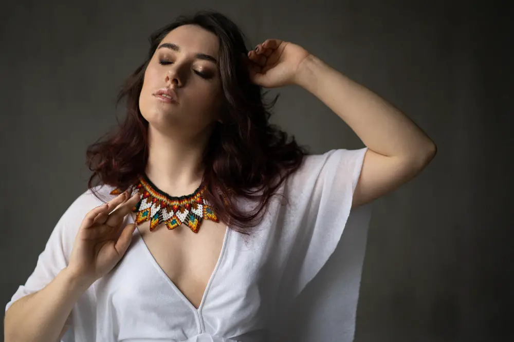 A close-up of a person wearing large, colorful statement jewelry that commands attention.